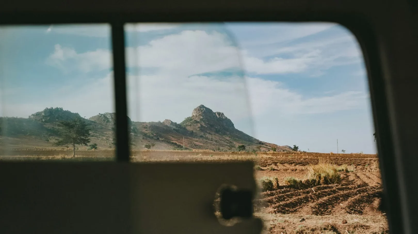 Un panorama époustouflant de collines se dévoile à travers la fenêtre, invitant à l'aventure et à l'exploration.