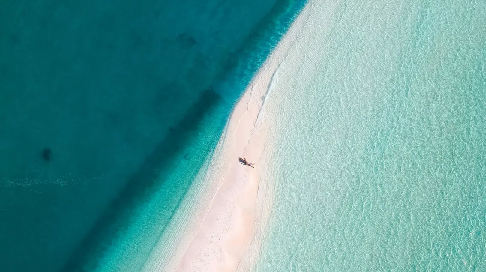 Plage paradisiaque aux eaux turquoise, bordée de sable fin et offrant un panorama enchanteur.